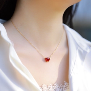 Minimalist S925 silver heart necklace with red gemstone pendant on a gold chain