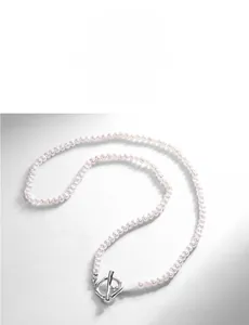 Close-up of white freshwater pearl necklace with silver metal OT toggle clasp detail