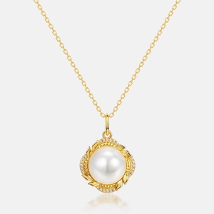 Detailed macro view of a large white pearl pendant with golden leaf frame and zircon inlay