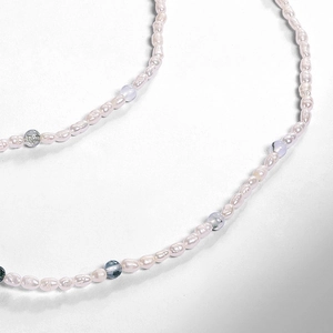 Macro detail of natural moss agate beads and baroque freshwater pearls on necklace