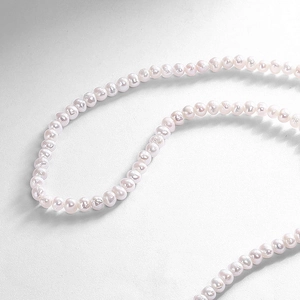 Detailed macro shot of high-quality freshwater pearls with natural luster and pink-white hue