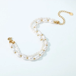 Elegant double-layered S925 silver gold-plated rice pearl bracelet with heart pendant