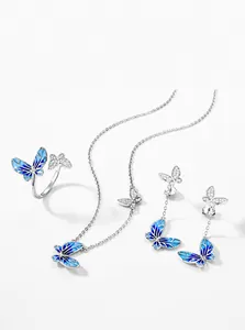 Detail of Plique-à-jour enamel butterfly jewelry set with zircon and silver finish