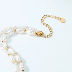 Double-layered S925 silver gold-plated pearl bracelet with heart pendant detail