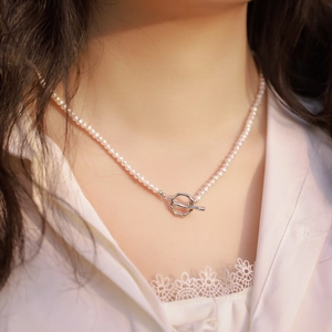 Elegant natural freshwater pearl necklace with silver OT buckle on a model's neck