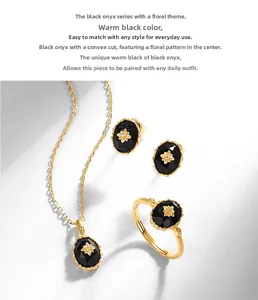Detailed set of black onyx jewelry including ring, necklace and studs in floral design