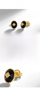 Macro detail of S925 hallmark on gold plated black agate oval stud earrings