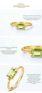 Detailed macro view of S925 silver snake ring with emerald-cut peridot gemstone