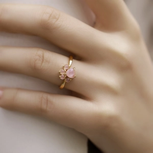 Sweet pink quartz cat paw ring in gold plating worn by a model for elegant look