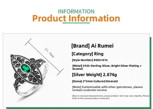 Macro detail of vintage 925 silver leaf ring with emerald and hollow engraving