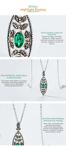Macro detail of S925 silver necklace with emerald pendant and fine polished texture