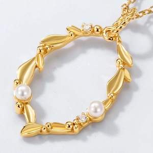Macro detail of S925 silver necklace pendant with freshwater pearls and leaf design