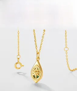 Detail of double-sided moss agate teardrop pendant with gold star engraving