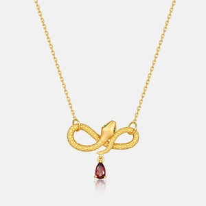 Gold-plated snake necklace with pear-cut garnet pendant and green gemstone accents