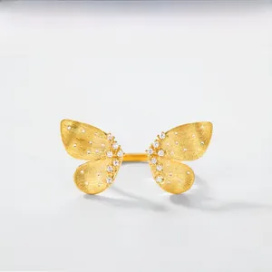 Detail of gold butterfly ring with Italian brushed texture and zircon accents