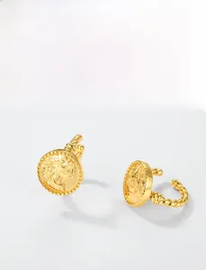 Macro detail of vintage coin relief earring cuffs with intricate braided rope patterns