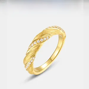 Macro detail of gold-plated Mobius ring with S925 hallmark and inlaid zircons