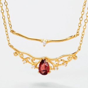 Macro detail of S925 silver double layer necklace with red pear-cut garnet pendant