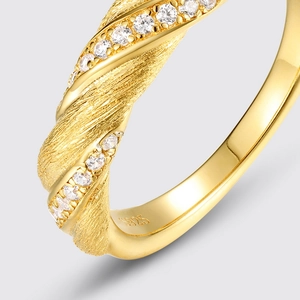 Macro shot of S925 silver gold-plated ring showing brushed texture and paved zircons