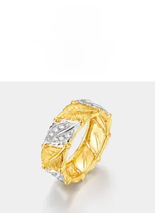 Macro detail of leaf-shaped silver and gold ring featuring fine texture and zircons