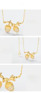 Detailed macro view of S925 sterling silver acorn pendant with zircon and gold plating