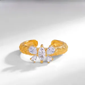 Detail of gold butterfly ring with marquise zircon and Italian brushed texture