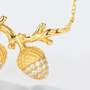 Detail of S925 silver hazelnut pendant with sparkling white cubic zirconia pavé setting