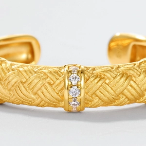 Retro gold woven cuff bracelet with triple zircon inlay and a brushed metal finish