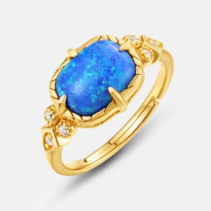 Elegant gold-plated S925 silver ring featuring an oval blue opal and side zircon accents