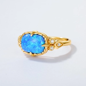 Vintage gold S925 silver ring with oval blue opal and micro-set zircon accents