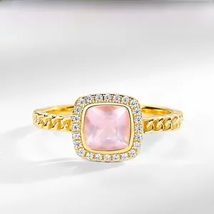 Detailed view of square pink crystal ring with S925 gold plating and twisted band texture