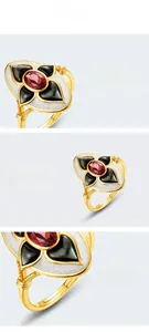 Macro details of Gothic sterling silver ring with garnet stone and black shell enamel