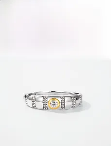 Close-up of bicolor S925 silver ring featuring a central moissanite and pavé set accents