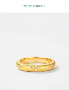 Close-up of S925 sterling silver gold plated ring with satin finish and small zircons