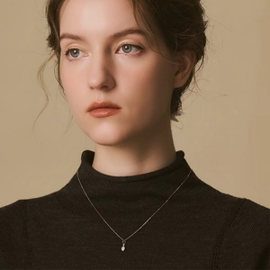 S925 sterling silver perfume bottle necklace with white opal teardrop on black sweater