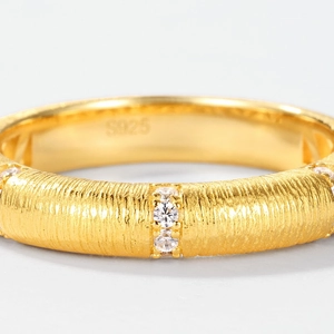 Macro detail of gold brushed S925 sterling silver ring with vertical zircon inlay