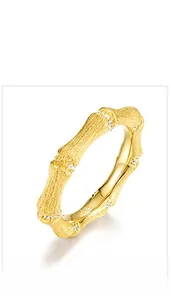 Detail view of gold bamboo style S925 silver ring with brushed texture and small diamonds