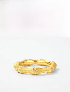 Detail of S925 silver gold-plated bamboo ring with brushed texture and small zircons