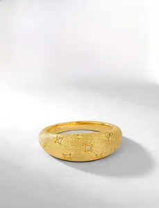 Detailed macro of S925 sterling silver ring with brushed gold texture and star engraving
