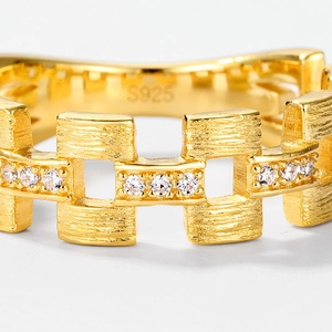 Macro shot of S925 sterling silver gold ring with brushed texture and zircon stones