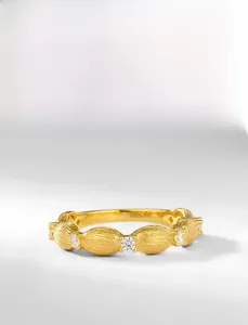 Macro detail of hand-brushed 925 silver ring with 10K gold plating and zircon stones