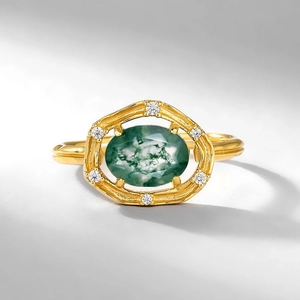 Vintage gold ring featuring oval green moss agate stone and small accent diamonds