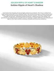 Detailed view of brushed gold heart ring featuring triple inlaid red garnets