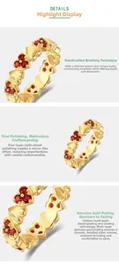 Detail view of heart-shaped S925 silver ring with red garnet and brushed gold finish