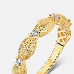 Macro view of brushed 10K gold plating on 925 silver ring with inlaid gemstones