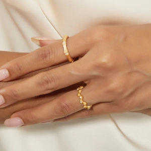 Elegant bamboo and wavy beaded gold rings with fine diamonds on textured metal band