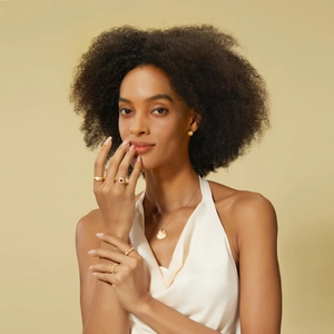 Close-up of matte gold bamboo style ring with pavé diamonds on a female model