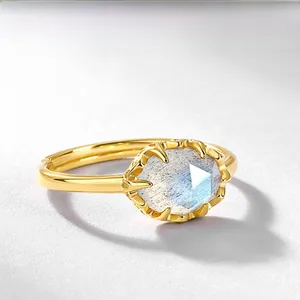 Macro shot of gold-plated silver ring with faceted moonstone and adjustable open band
