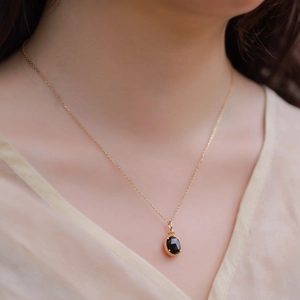 Elegant S925 silver gold plated necklace with oval smoky quartz pendant on a model