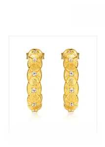 Close-up of golden petal-shaped earrings with brushed texture and inlaid zircons